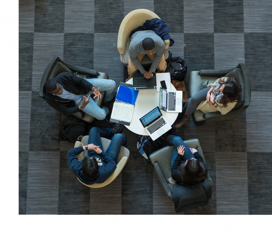 Overhead view of 5 students sitting at round table